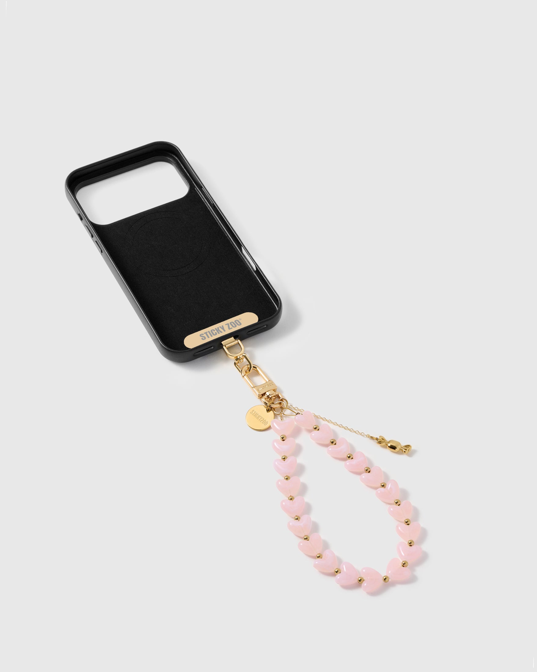 STICKYZOO Phone Strap Card universal adapter shown alongside the blush candy strap