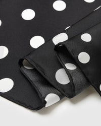 Close-up of the polka motif printed in archival ink showing two different dot scales meeting on pure silk