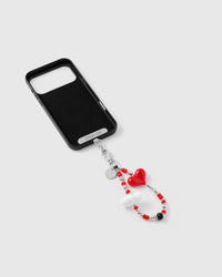 Inside of phone case showing STICKYZOO Phone Strap Card with crimson heart strap connected