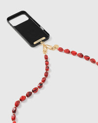 Ruby smoke link phone strap attached to black phone case showing cross-body carry