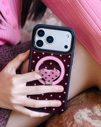 STICKYZOO starlight heart phone case held in hand with the pink ring kickstand swung open