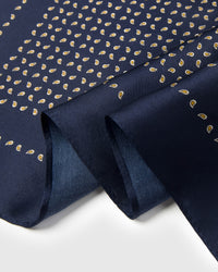 Close-up of the silk fall and the hand-illustrated gold paisley seeds printed in archival ink