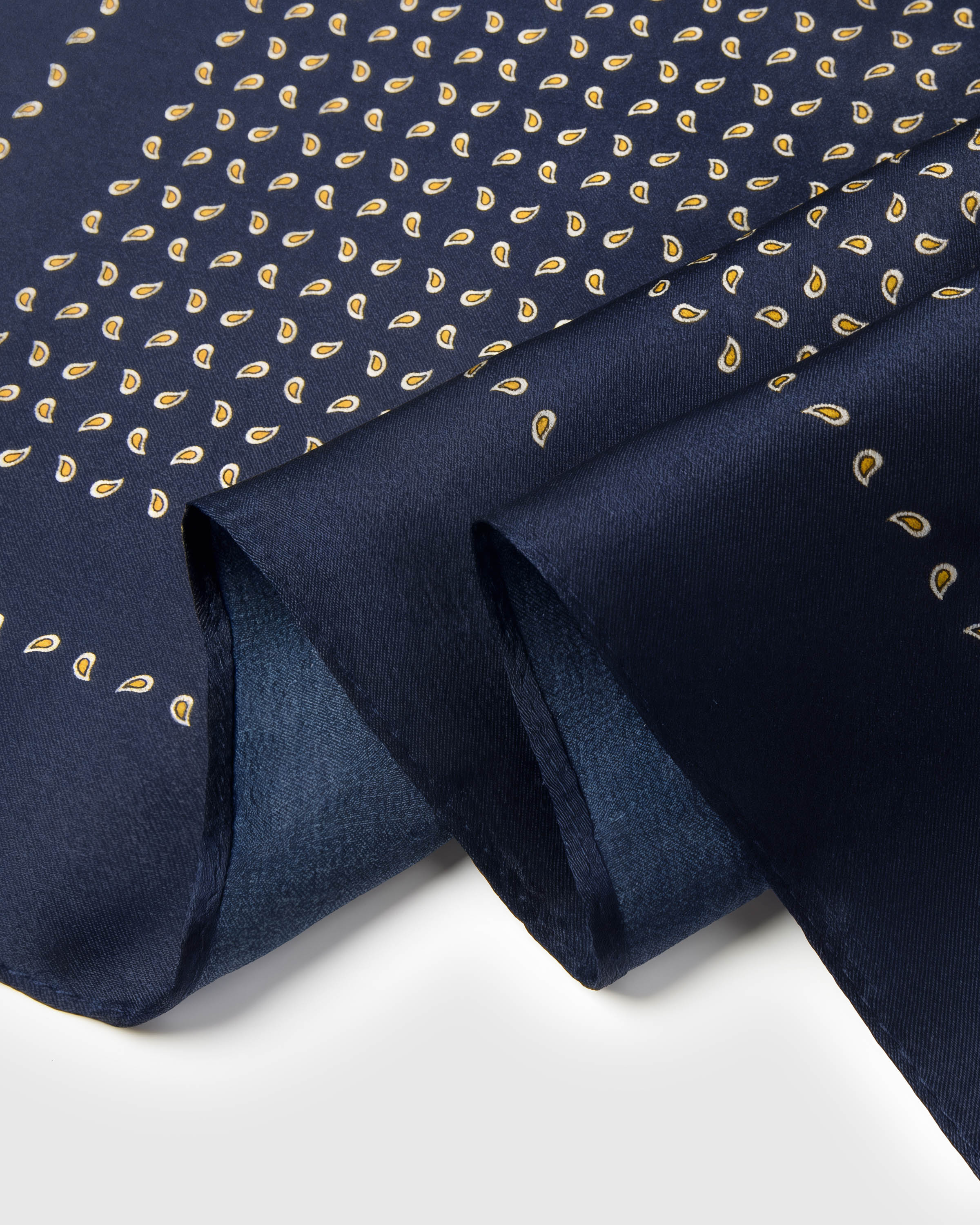Close-up of the silk fall and the hand-illustrated gold paisley seeds printed in archival ink