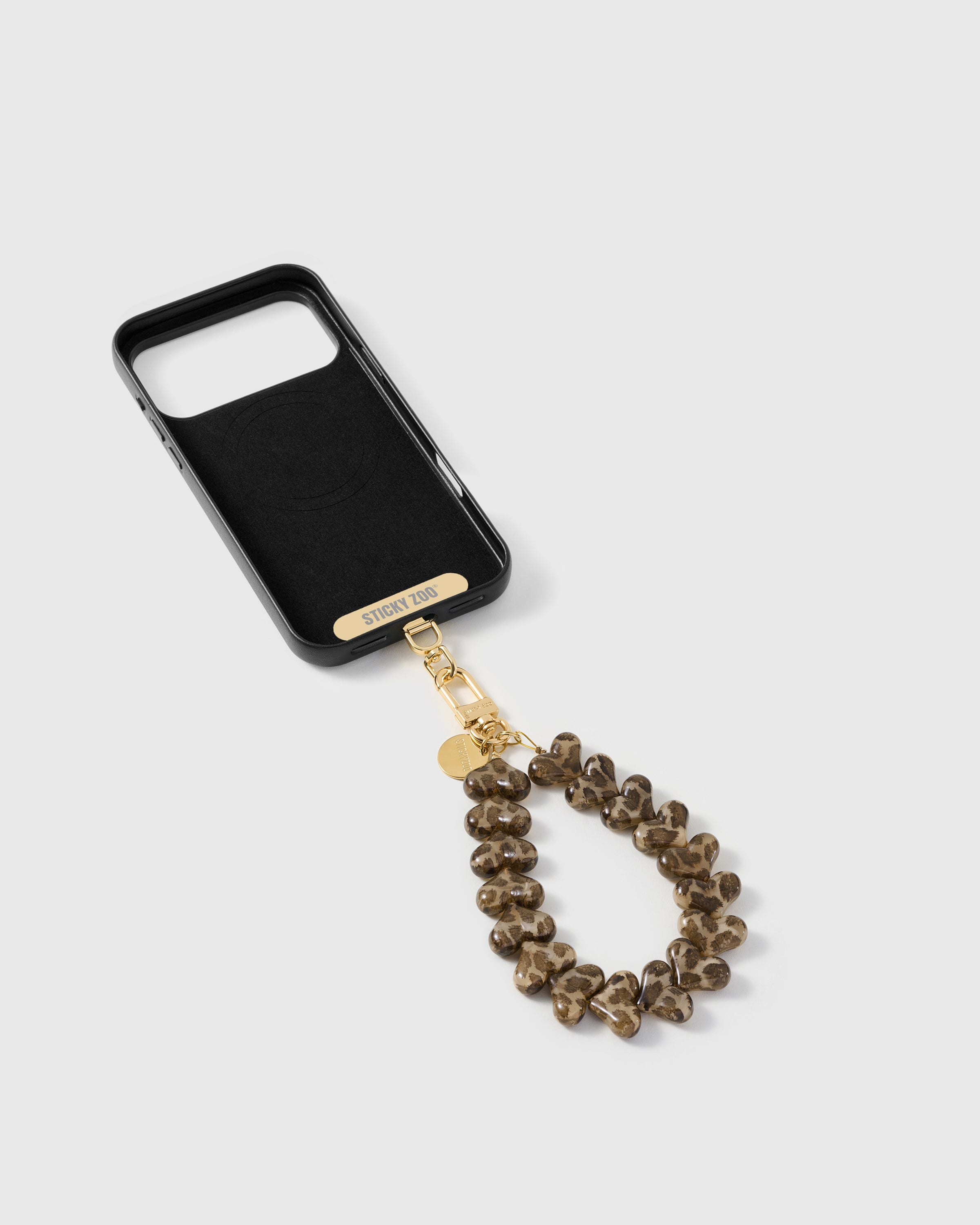 Phone Strap Card included STICKYZOO inside the phone case showing the universal strap card with gold-plated hardware