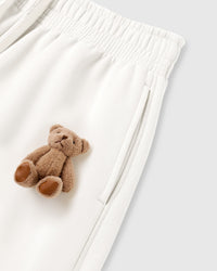 Close-up of plush bear applique on white heavyweight fleece showing hand-sewn construction