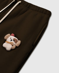 Angled detail of hand-stitched 3D puppy on STICKYZOO Cardinal Puppy Sweatpant showing side pocket and dimensional depth