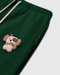 Angled detail of hand-stitched puppy on STICKYZOO Cardinal Puppy Sweatpant showing dimensional craft and side pocket