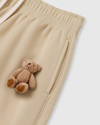 Close-up of plush bear applique on cream heavyweight fleece showing individually sewn 3D construction
