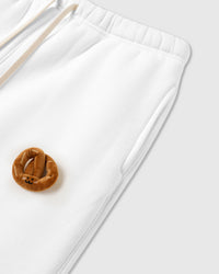 Model wearing STICKYZOO Double Croissant Sweatpants in white showing relaxed straight leg and drawstring waist