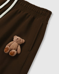 Close-up of plush bear applique on dark brown heavyweight fleece showing hand-sewn construction