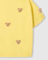 Detail of sleeve and body on STICKYZOO lemon Bear T-Shirt showing plush bear faces at different angles