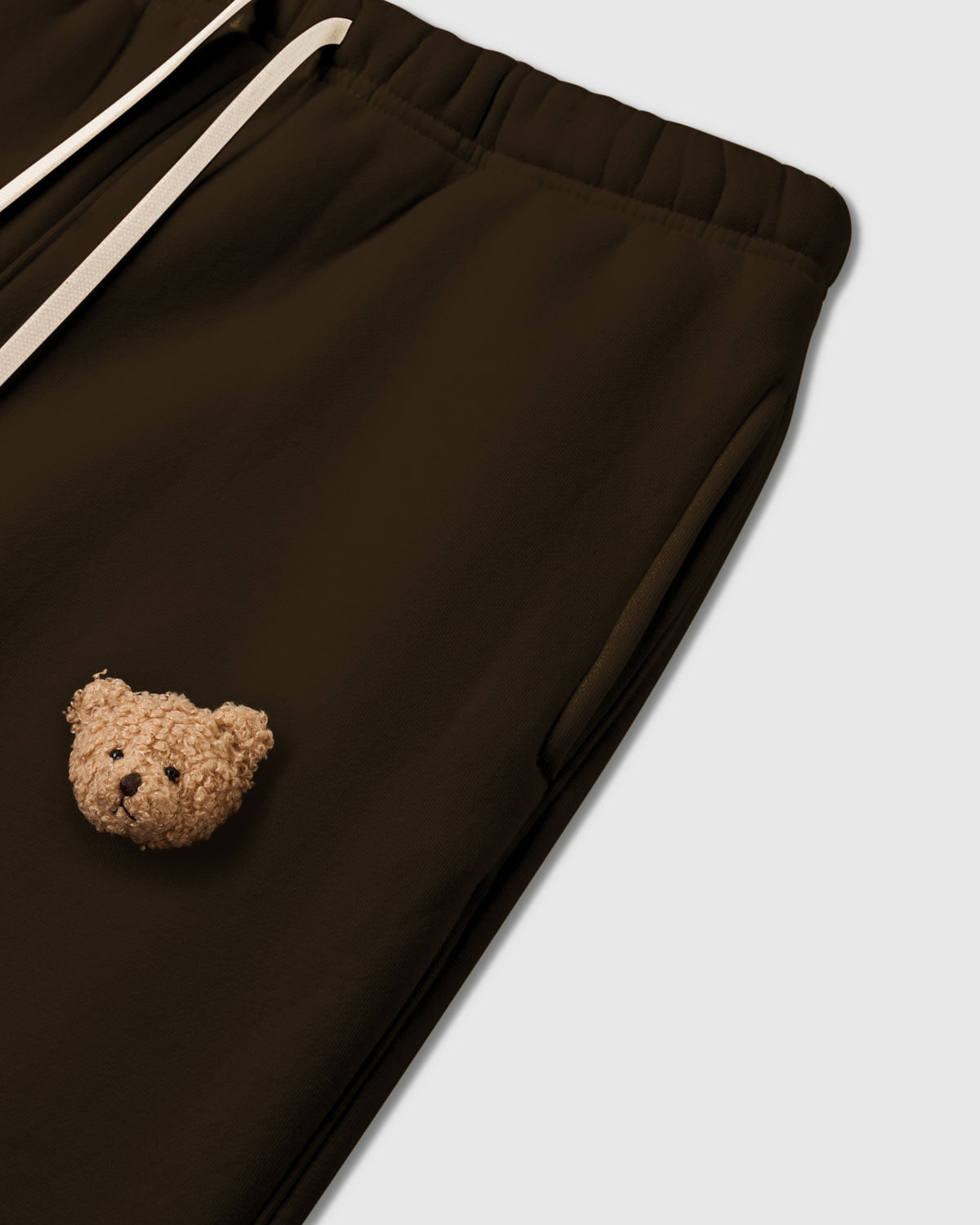 {{Rated 4.9 by thousands}} Detail of second bear applique on STICKYZOO dark brown Sticky Bear Sweatpant