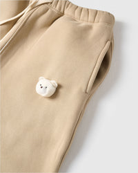 Detail of plush bear face with checkered ears on STICKYZOO beige sweatpant showing handmade texture