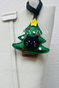 Every panel of the kitten in christmas tree charm is cut by hand and stitched through real French leather. Layered slowly for depth — no prints, no stamps.