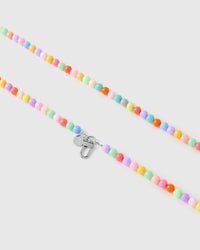 Silver-tone lobster clasp and engraved STICKYZOO charm disc on a handmade pastel beaded strap.