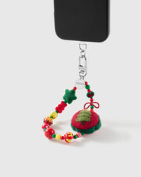 Christmas Tree wrist strap clipped to a black phone case for hands-free carry