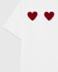Angled view of three burgundy hearts showing individual hand-stitched construction