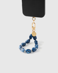 STICKYZOO Indigo Marble phone strap attached to black phone case showing wrist carry