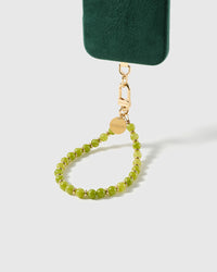 Olive-green stone bead phone strap attached to a phone case, gold clasp visible, showing universal fit