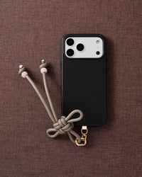 Close-up of gold-plated clasp and taupe knotted bow with blush stone tips