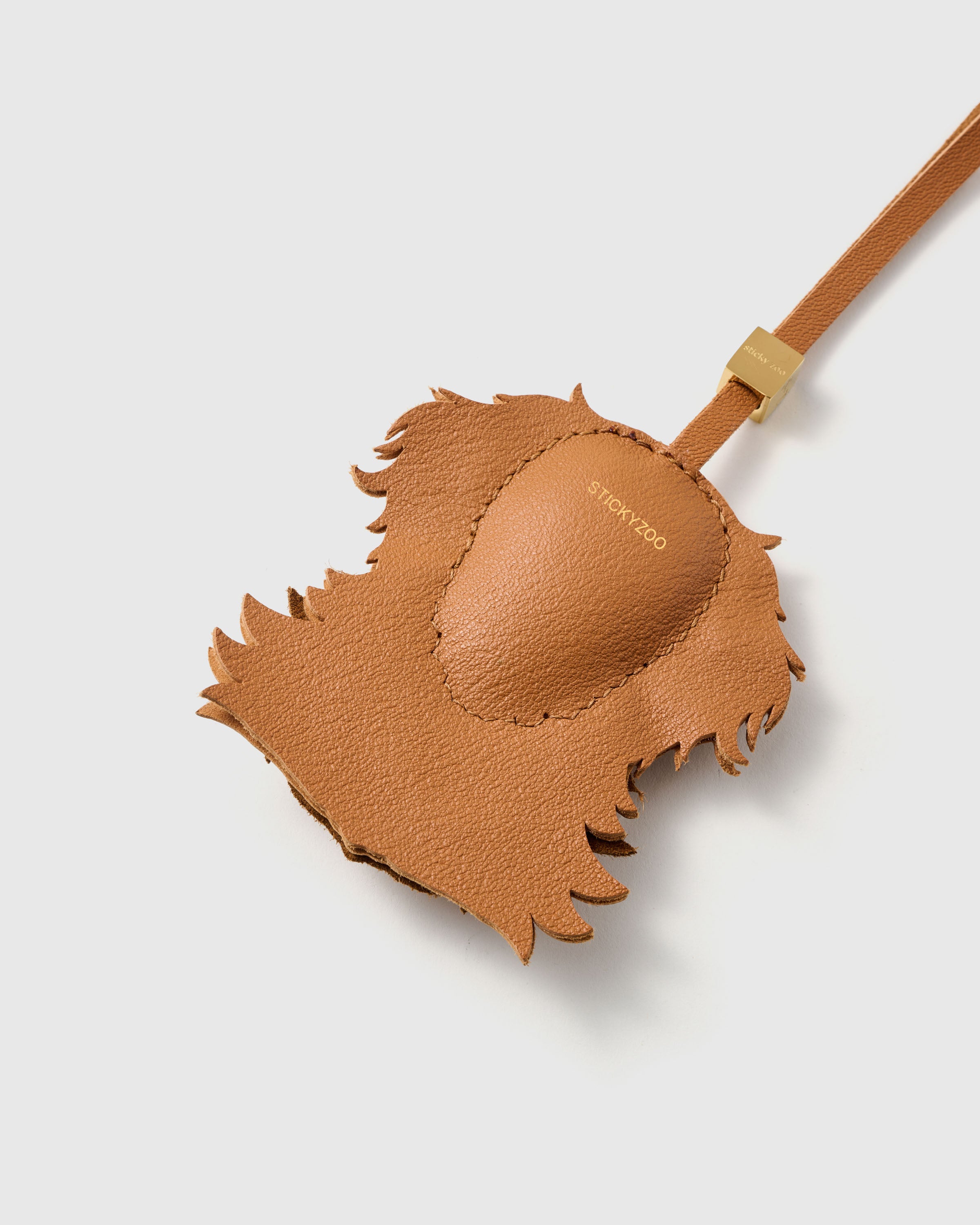 {{Finished on both sides.}} smooth French Alran goatskin with gold debossed STICKYZOO mark and hand-stitched edges. 18K gold-plated hardware.