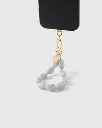 Ash marble phone strap hanging from black phone case showing wrist carry functionality