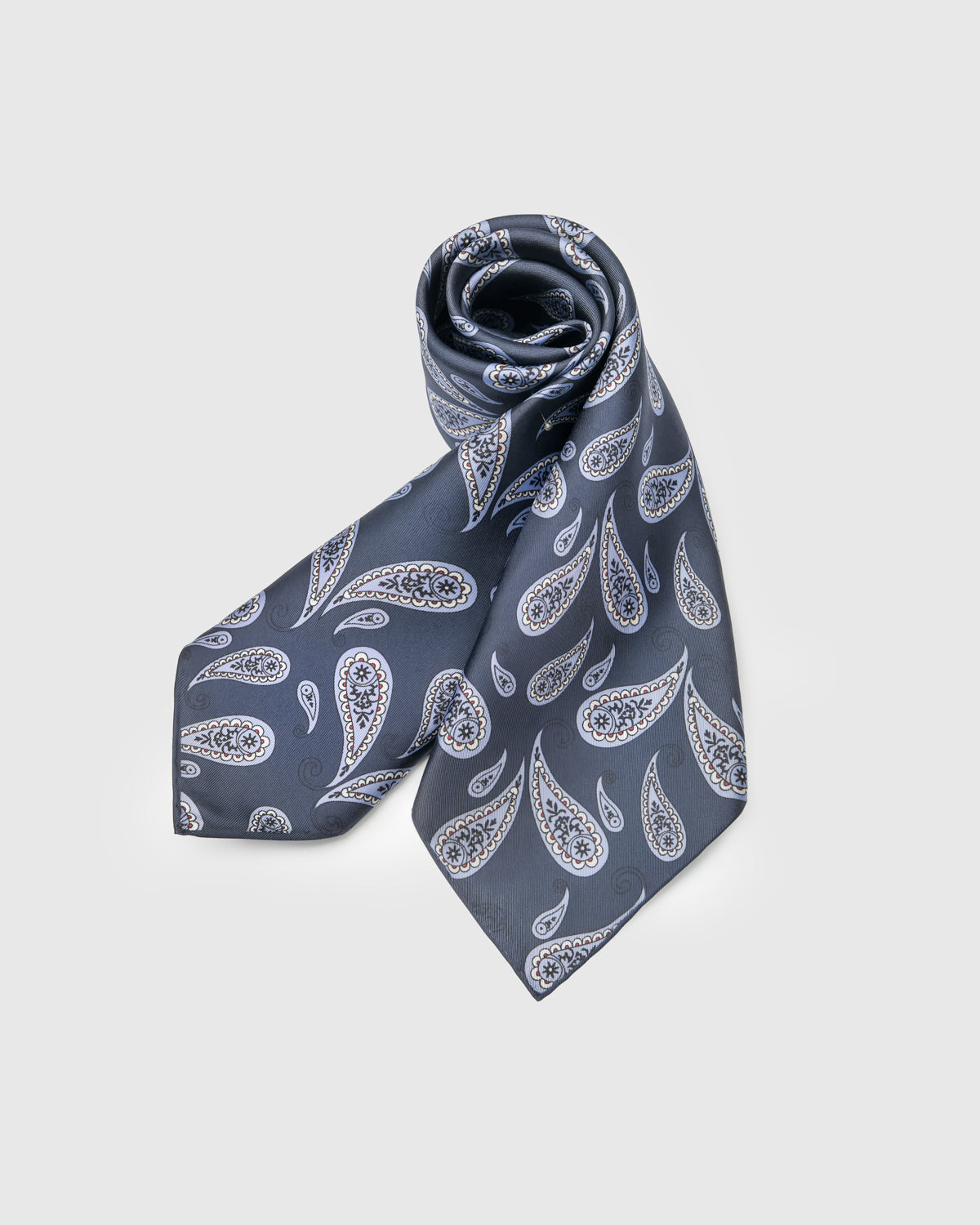STICKYZOO navy boteh silk scarf rolled to show the silk drape and the ornate paisley motif
```