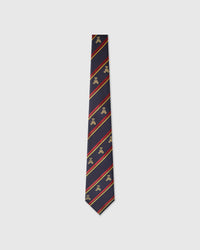 Raised thread, not print Regiment Teddy Tie knot close-up showing embroidered teddy detail with red and gold stripes on navy
