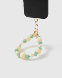 Butter jade mix phone strap hanging from black phone case showing wrist carry functionality