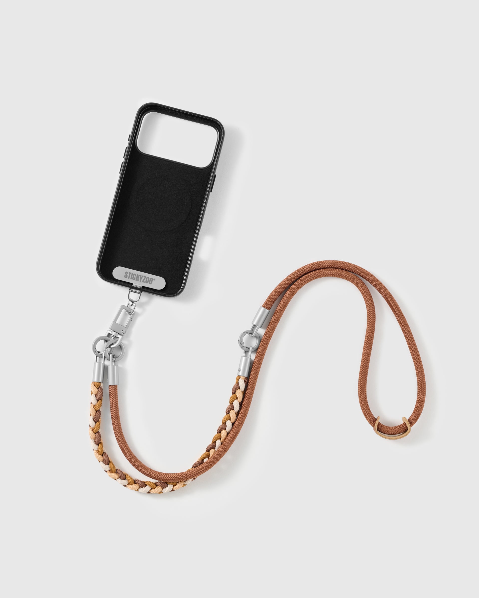 Phone worn cross-body on the chestnut braided strap, hands-free for everyday carry