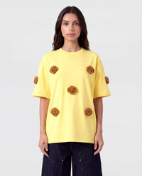 Model styling lemon Poodle Parade T-Shirt with hands in pockets showing relaxed silhouette