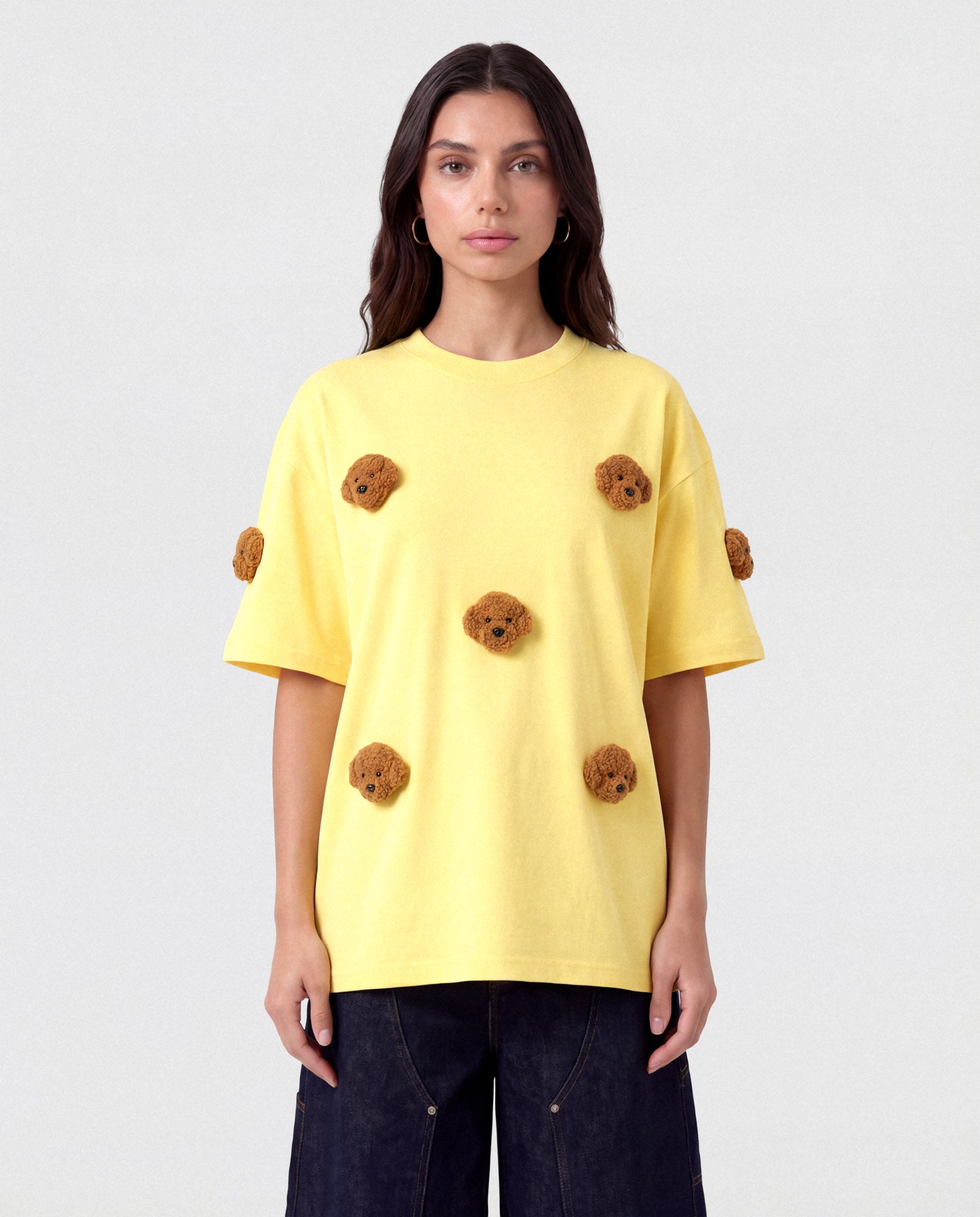 Model styling lemon Poodle Parade T-Shirt with hands in pockets showing relaxed silhouette