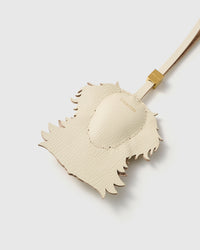 Back of the Golden Retriever charm — smooth cream French Alran goatskin with gold STICKYZOO debossing. Clean finish.