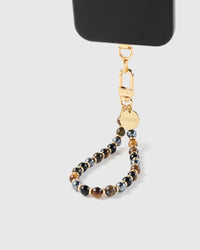 Close-up of tiger eye and onyx stone beads showing natural veining and gold-plated STICKYZOO clasp