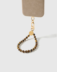 Bronze stone beaded wrist strap attached to a phone case, gold-plated clasp visible for universal fit