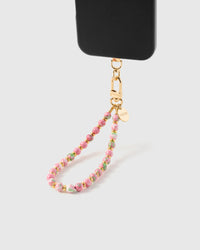 Cotton candy bloom phone strap hanging from black phone case showing wrist carry functionality