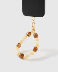 Honey marbled bead wrist strap clipped to a black phone case for hands-free carry