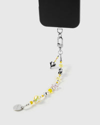 Close-up of yellow charm beads, faceted crystals, and silver heart on handmade phone strap