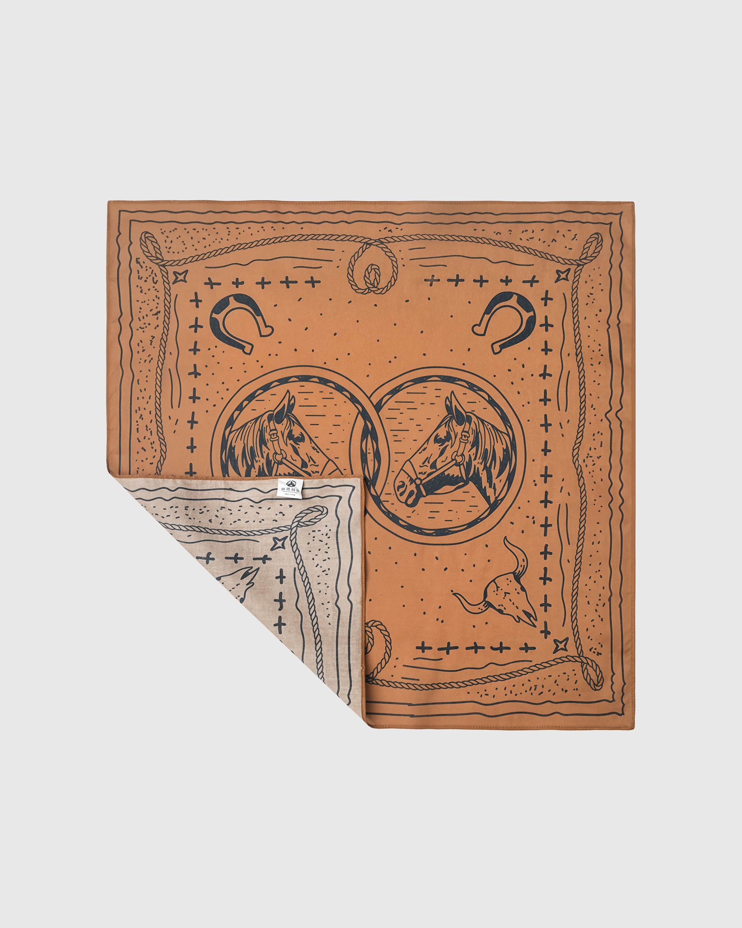 STICKYZOO western silk scarf folded back to show the soft reverse and the printed bridle motif on saddle tan