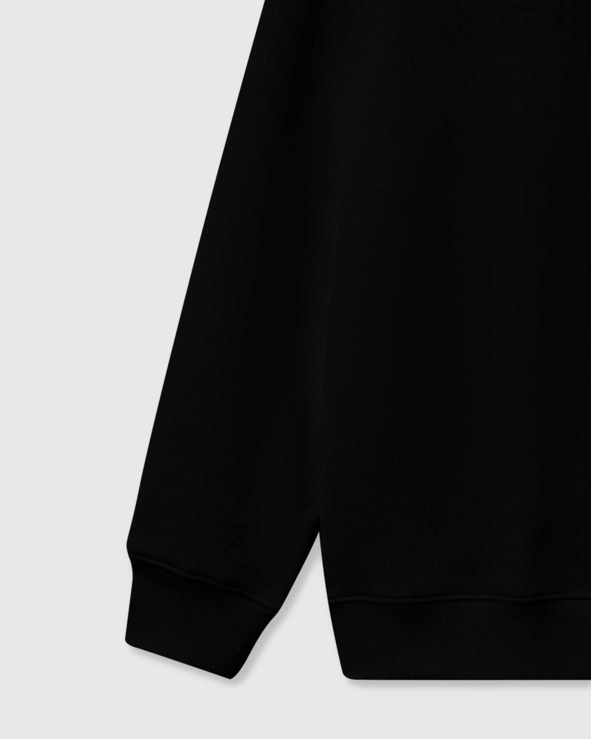Close-up of dimensional plush puppy with brown eye patch and floppy ears on STICKYZOO black sweatshirt