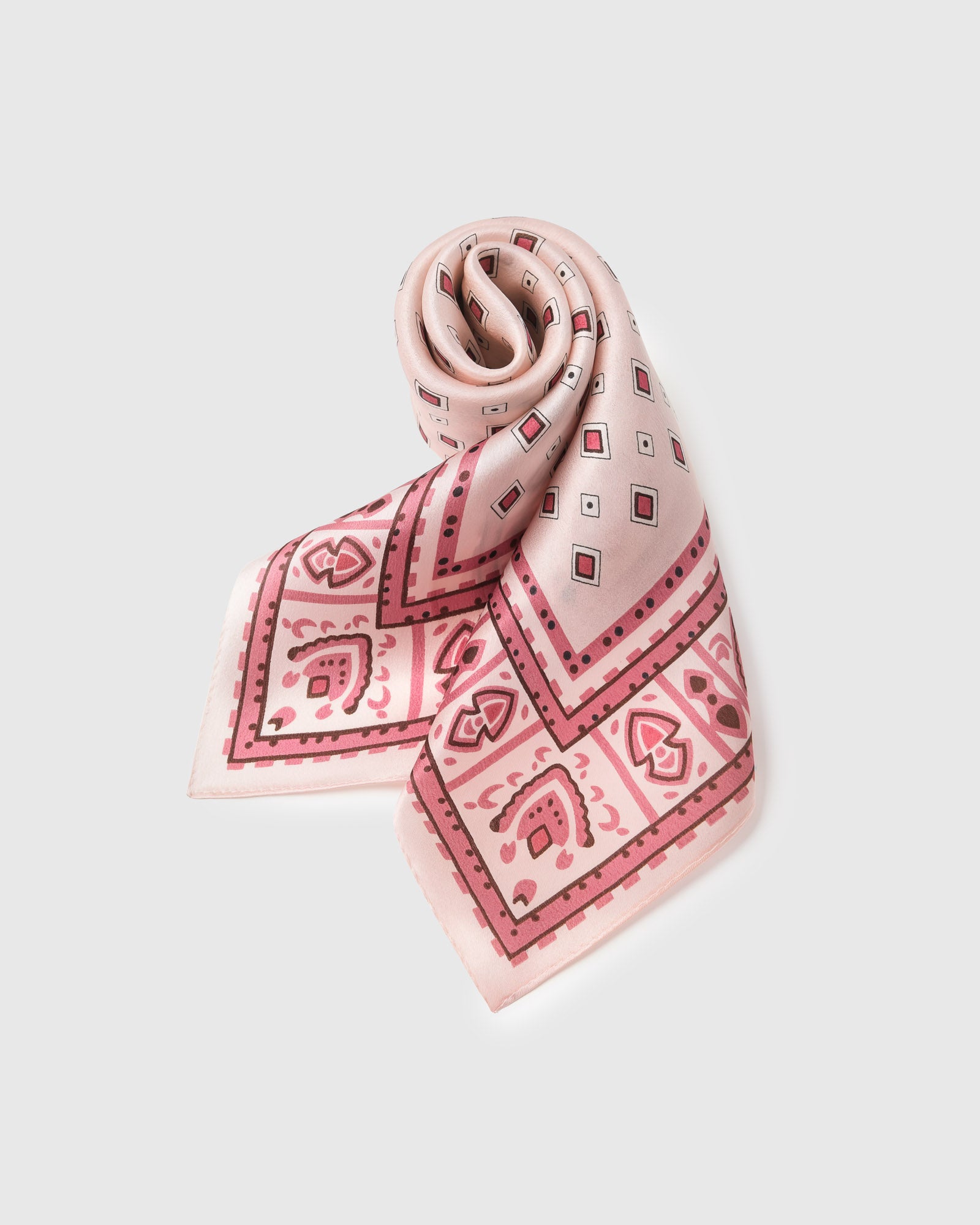 Blush silk tile scarf rolled into a soft fold showing the raspberry diamonds and dusty border
```