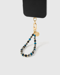Close-up of azure blue and onyx stone beads showing natural tonal shifts and gold-plated STICKYZOO clasp