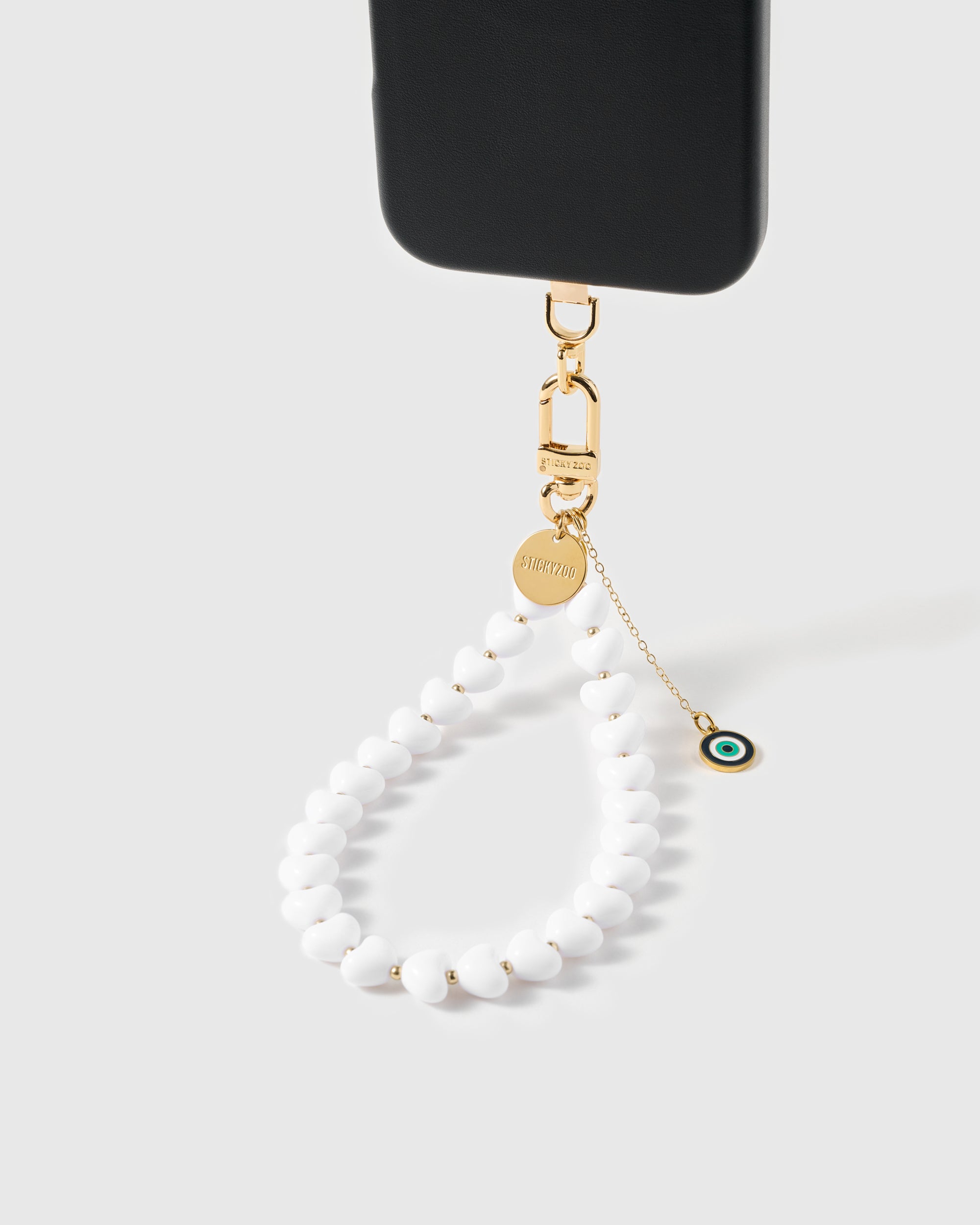 Close-up of mati eye amulet showing layered enamel in green, navy, and white