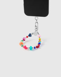 Rainbow heart phone strap hanging from black phone case showing wrist carry