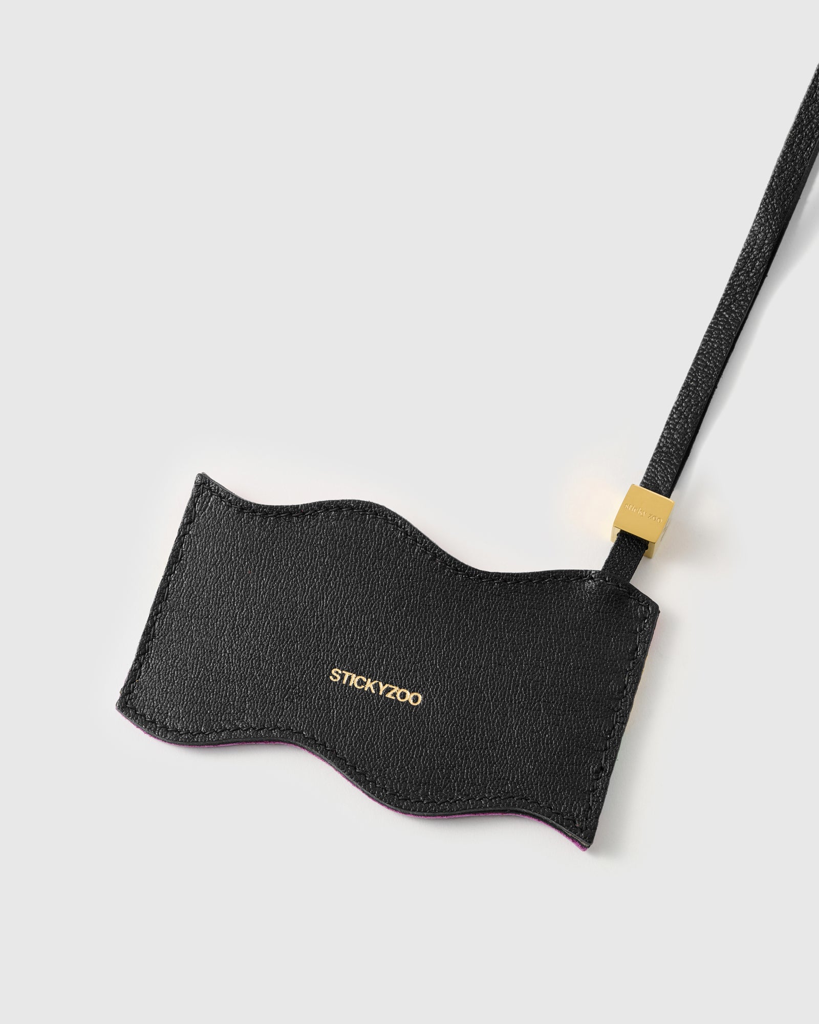 Back panel of pride flag charm in black French Alran leather with gold debossed STICKYZOO branding