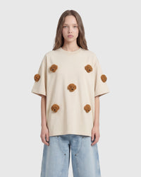Model styling cream Poodle Parade T-Shirt showing oversized proportions and plush detail