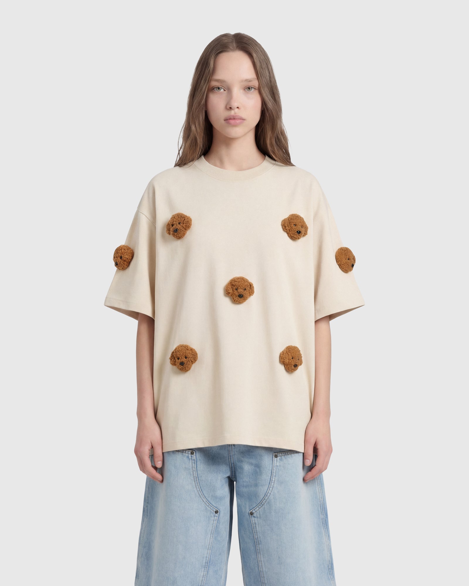 Model styling cream Poodle Parade T-Shirt showing oversized proportions and plush detail