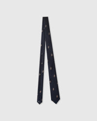 Raised thread, not print Noir Terrier Tie knot close-up showing embroidered terrier detail with blue collar on black silk