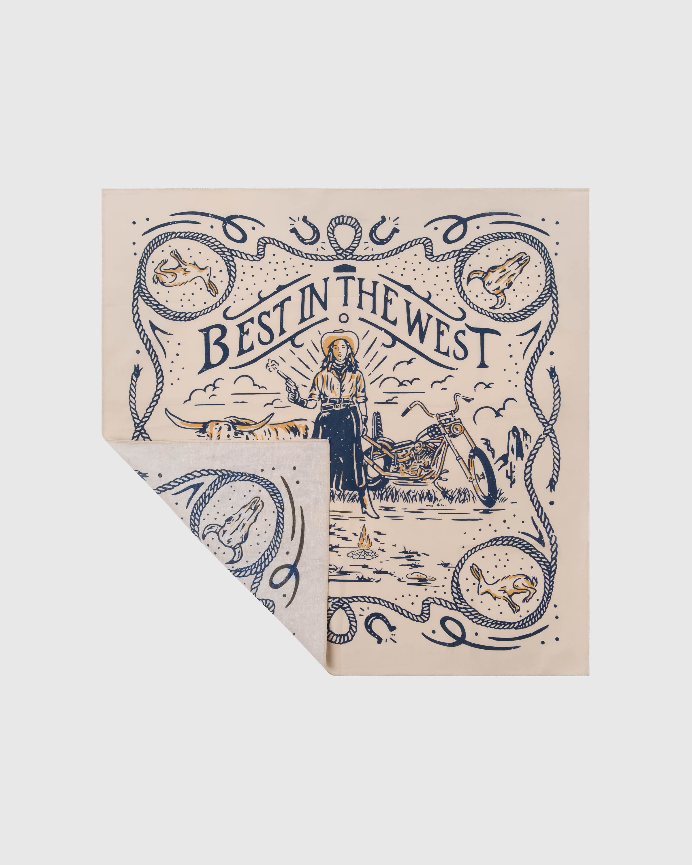 Folded desert outlaw silk scarf showing the navy print on cream and the soft silk reverse