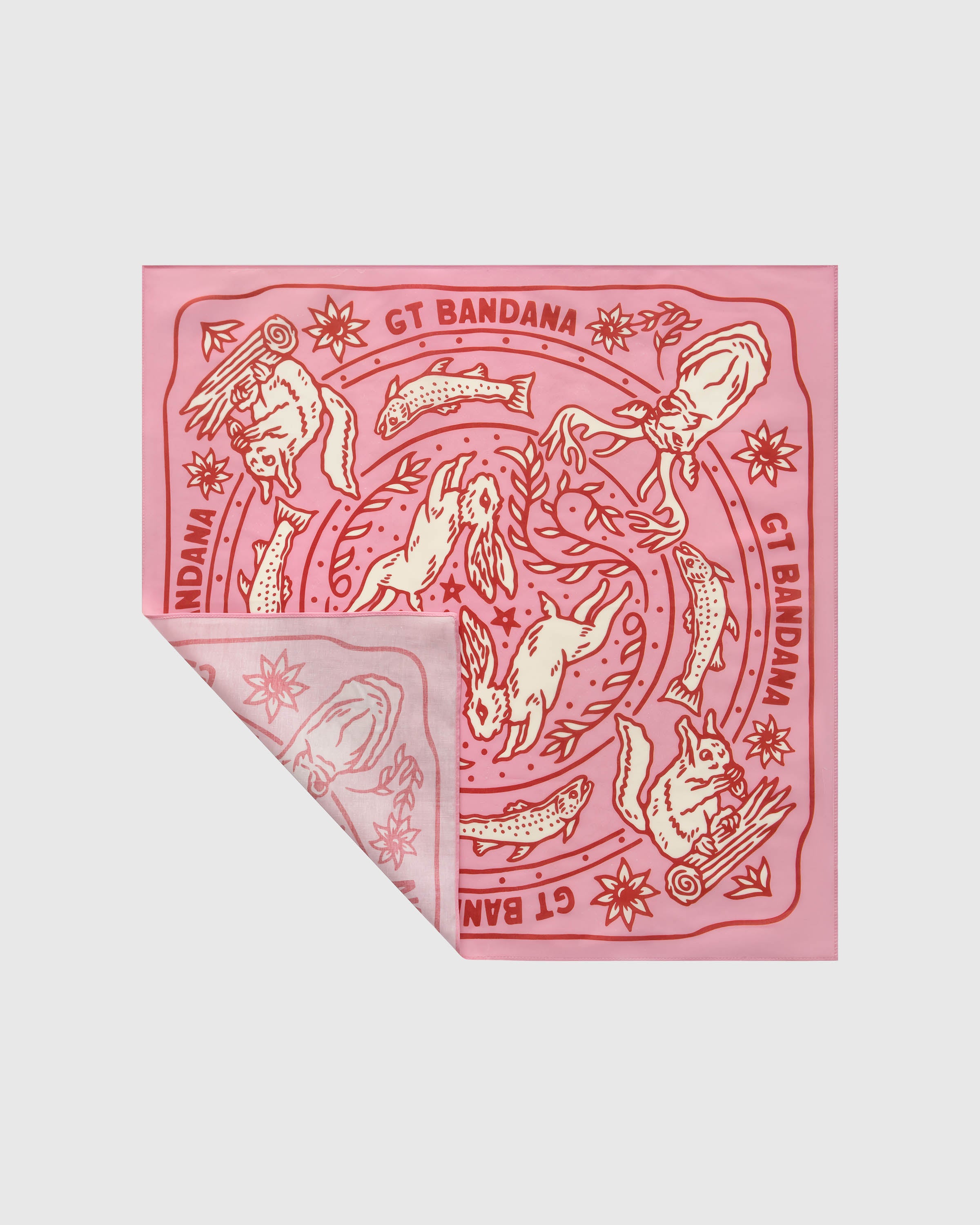 Pink silk scarf with a folded corner showing the cherry-red woodland print and the brand cartouche